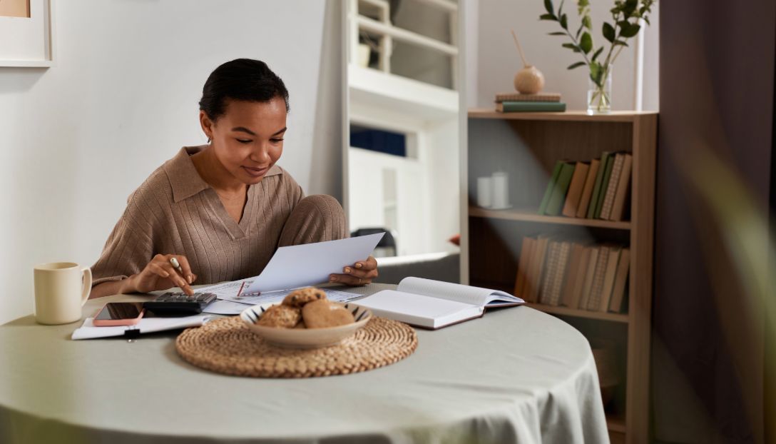woman managing her finances at her table
