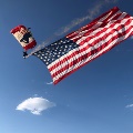 Double Amputee Veteran paragliding with the American flag